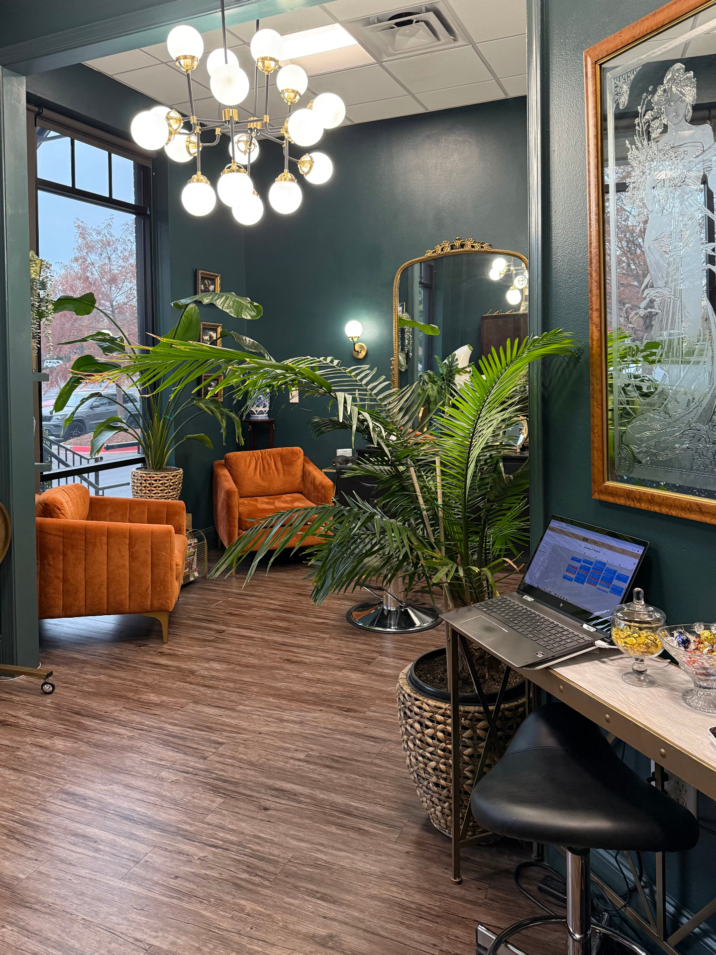Spring Factor Studio waiting area with velvet chairs and large plants